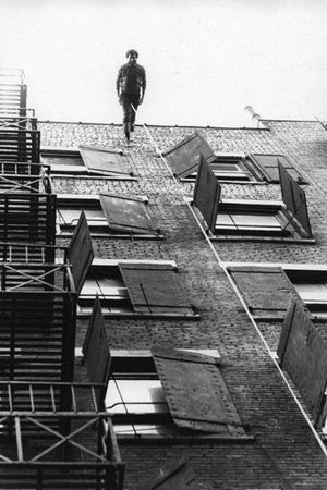 Man Walking Down the Side of a Building's poster