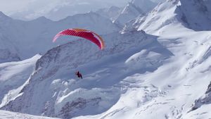 Ueli Steck - Paraglides Between Mountains In The Swiss Alps's poster